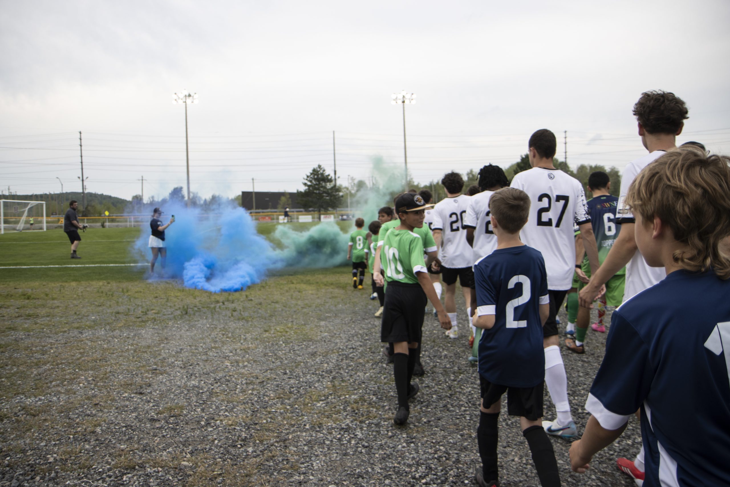 Kids walking onto the pitch alongside Sudbury Cyclones players